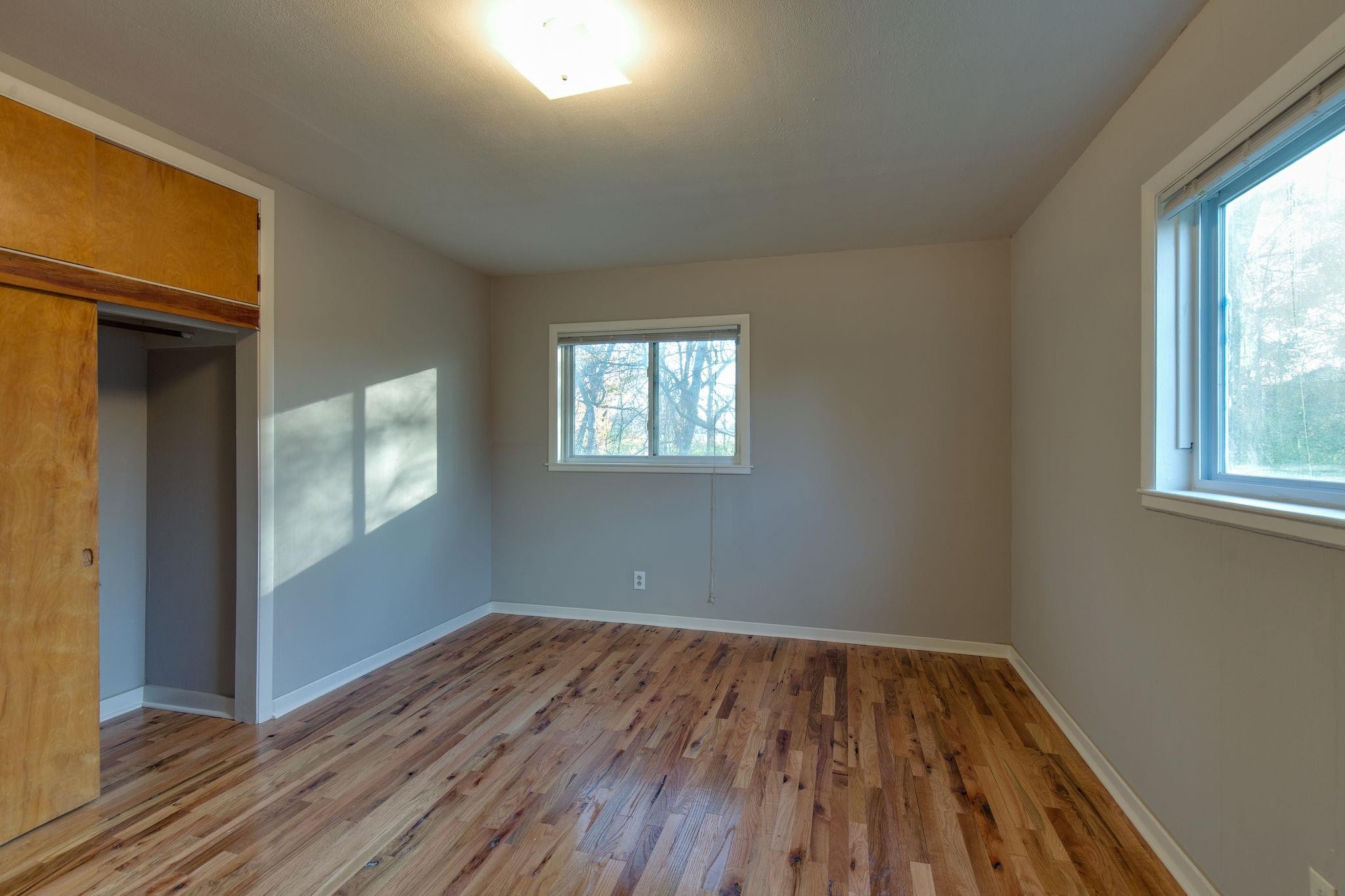 256 Manzano Road Madison, TN 37115 - Photo 14 of 24 an empty room with wooden floor and windows