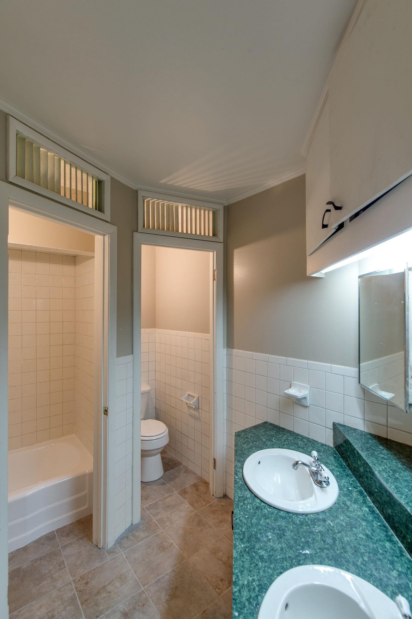 256 Manzano Road Madison, TN 37115 - Photo 15 of 24 a bathroom with a granite countertop sink a toilet a mirror and shower