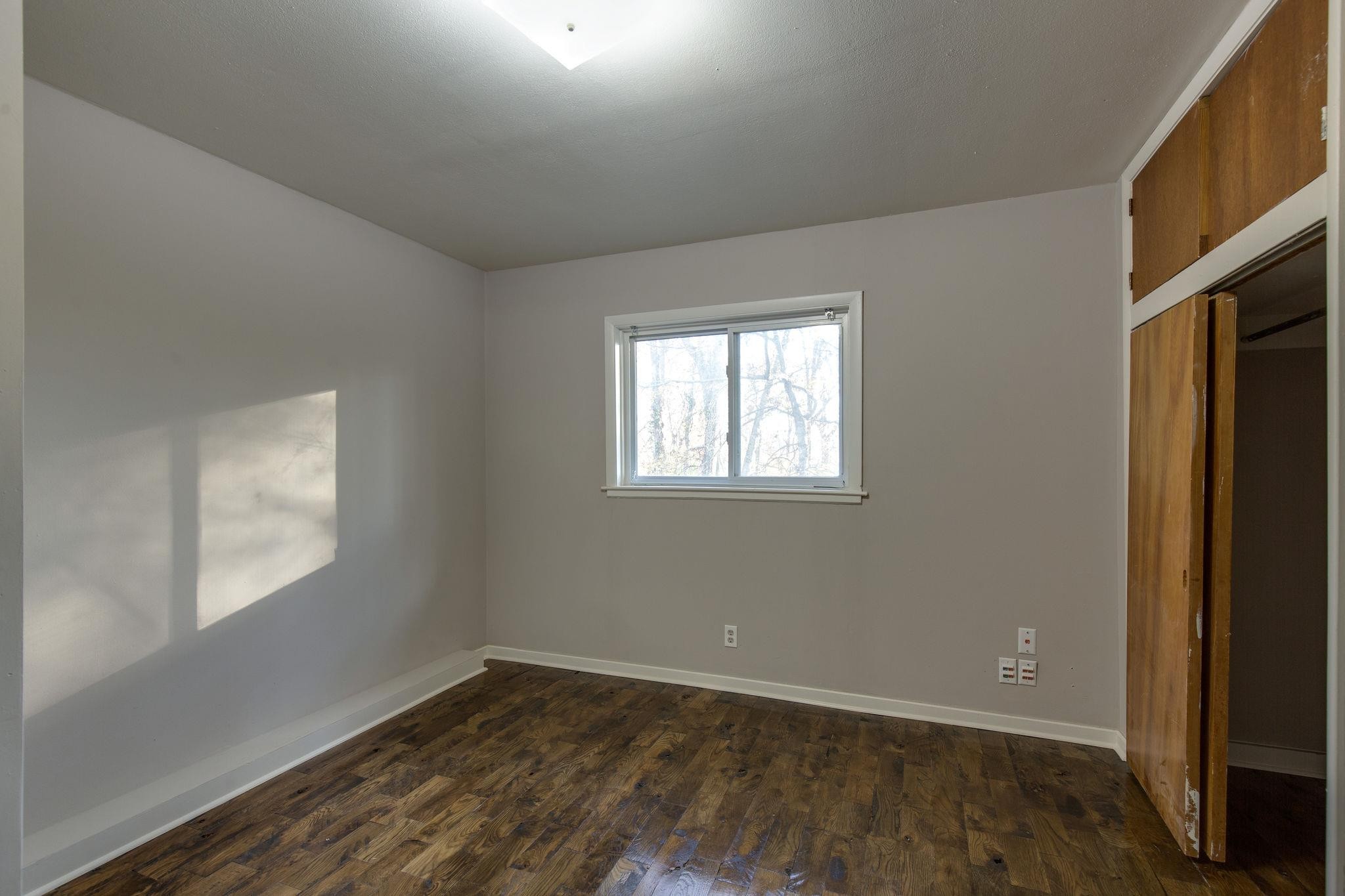 256 Manzano Road Madison, TN 37115 - Photo 19 of 24 an empty room with wooden floor and windows