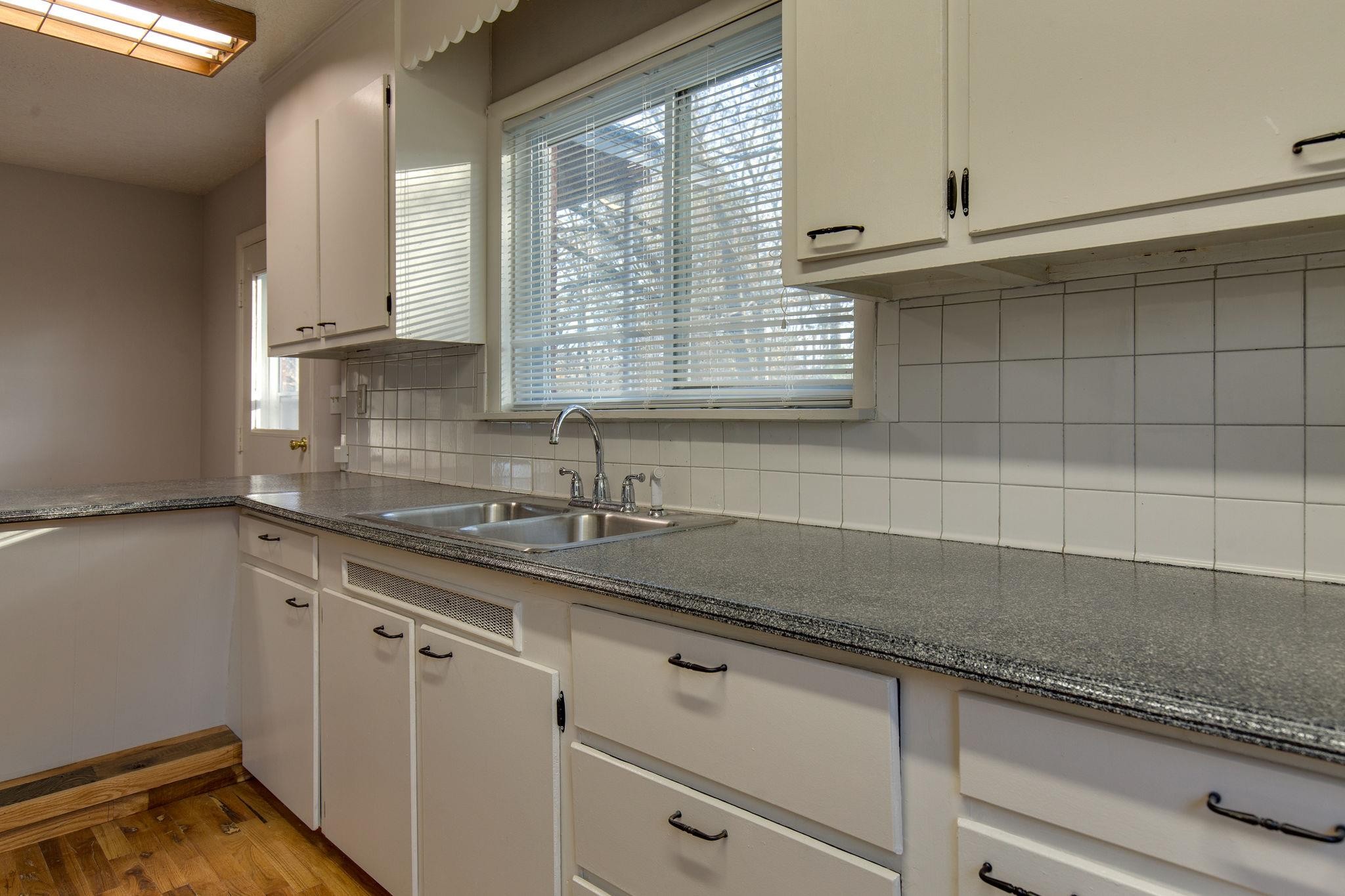 256 Manzano Road Madison, TN 37115 - Photo 6 of 24 a kitchen with granite countertop cabinets sink and window