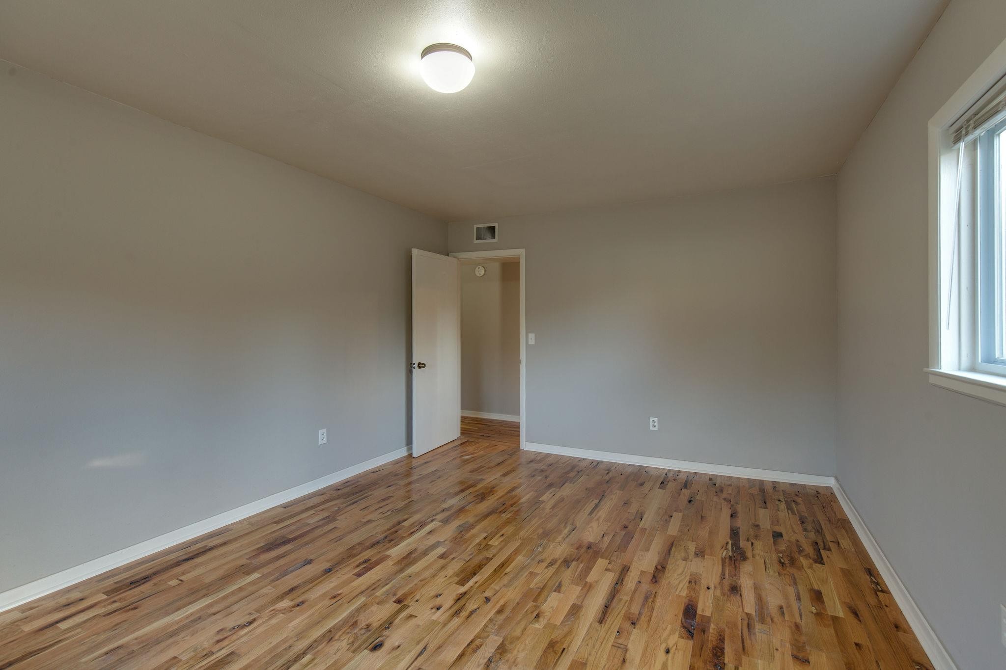 256 Manzano Road Madison, TN 37115 - Photo 7 of 24 an empty room with wooden floor and windows