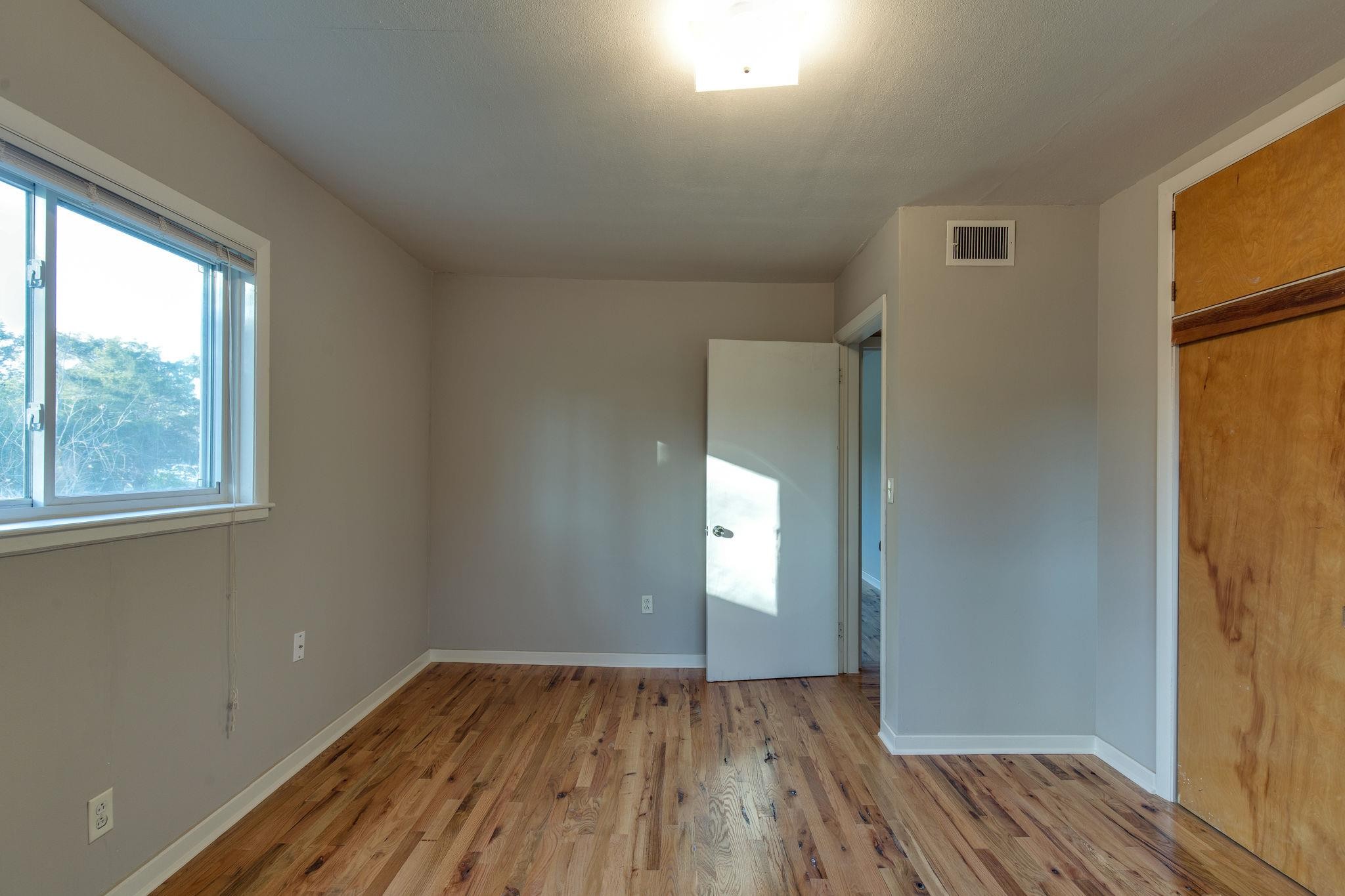 256 Manzano Road Madison, TN 37115 - Photo 10 of 24 a view of empty room with window and wooden floor