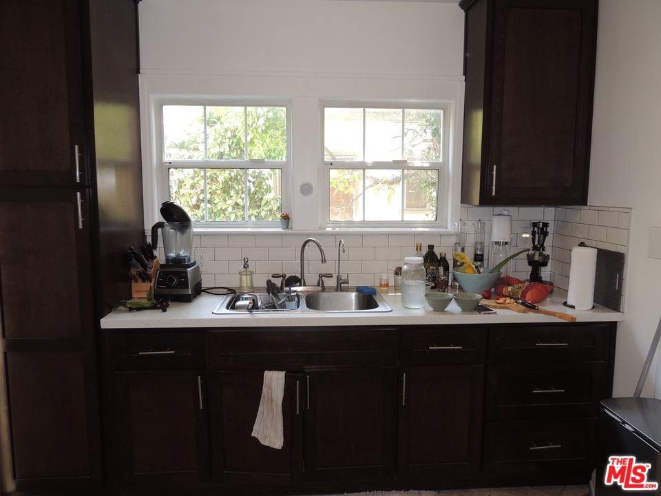 908 Victoria Avenue Venice, CA 90291 - Photo 19 of 25 a kitchen with sink a window and cabinets