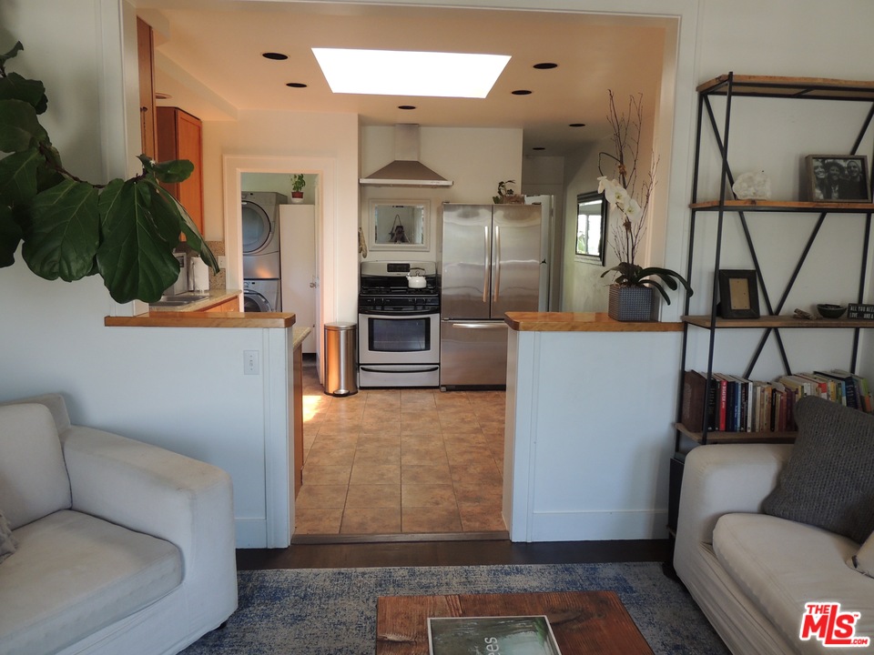 908 Victoria Avenue Venice, CA 90291 - Photo 3 of 25 a living room with furniture and a rug