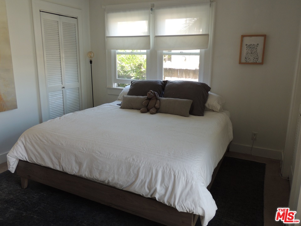 908 Victoria Avenue Venice, CA 90291 - Photo 8 of 25 a bed sitting in a bedroom next to a window