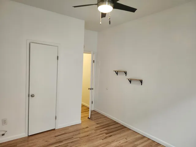 an empty room with wooden floor