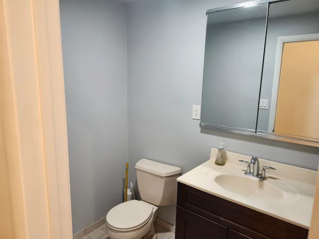 a bathroom with a sink a toilet and mirror