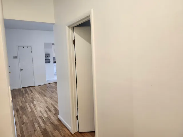 a view of a room with wooden floor