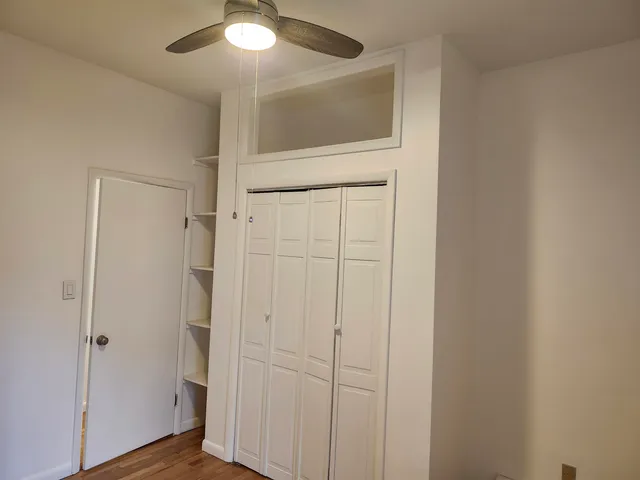 a view of a hallway with wooden floor