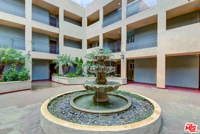 a view of a house with fountain in front of a building