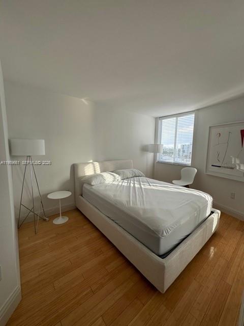 1621 Bay Road, Unit 708 Miami Beach, FL 33139 - Photo 6 of 13 a bedroom with a bed and window
