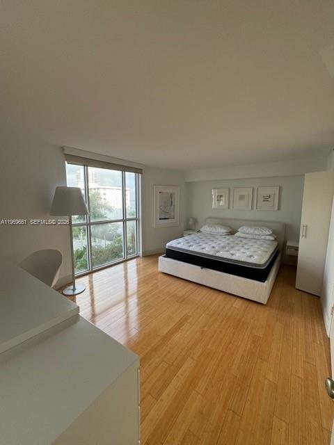 1621 Bay Road, Unit 708 Miami Beach, FL 33139 - Photo 7 of 13 a bedroom with a bed and a large window