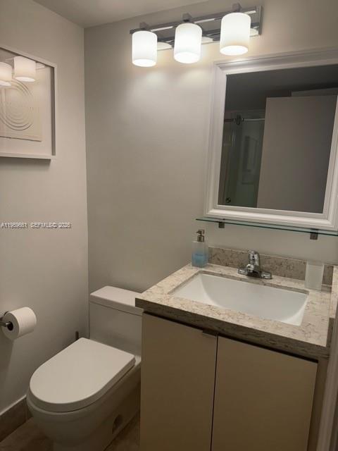 1621 Bay Road, Unit 708 Miami Beach, FL 33139 - Photo 10 of 13 a bathroom with a granite countertop toilet sink and mirror