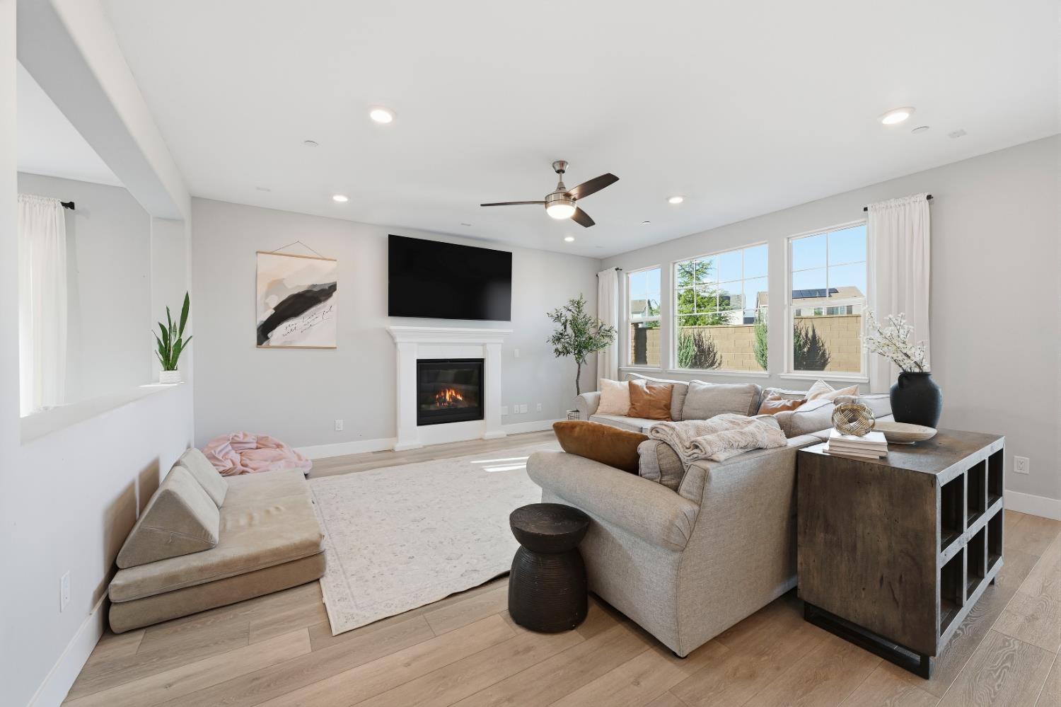 810 Broken Bit Court Rocklin, CA 95765 - Photo 16 of 47 a living room with furniture a fireplace and a flat screen tv