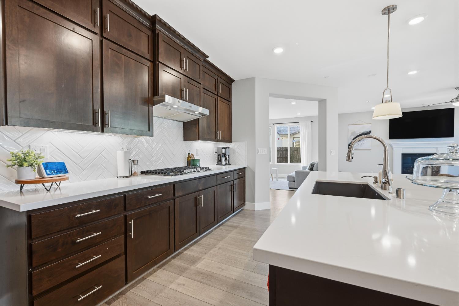 810 Broken Bit Court Rocklin, CA 95765 - Photo 18 of 47 a large kitchen with stainless steel appliances a sink a stove and a wooden floors