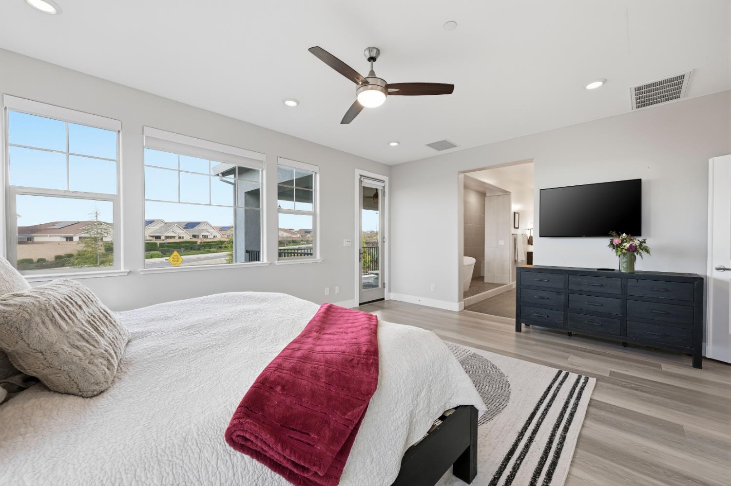 810 Broken Bit Court Rocklin, CA 95765 - Photo 23 of 47 a spacious bedroom with a large bed and a flat screen tv