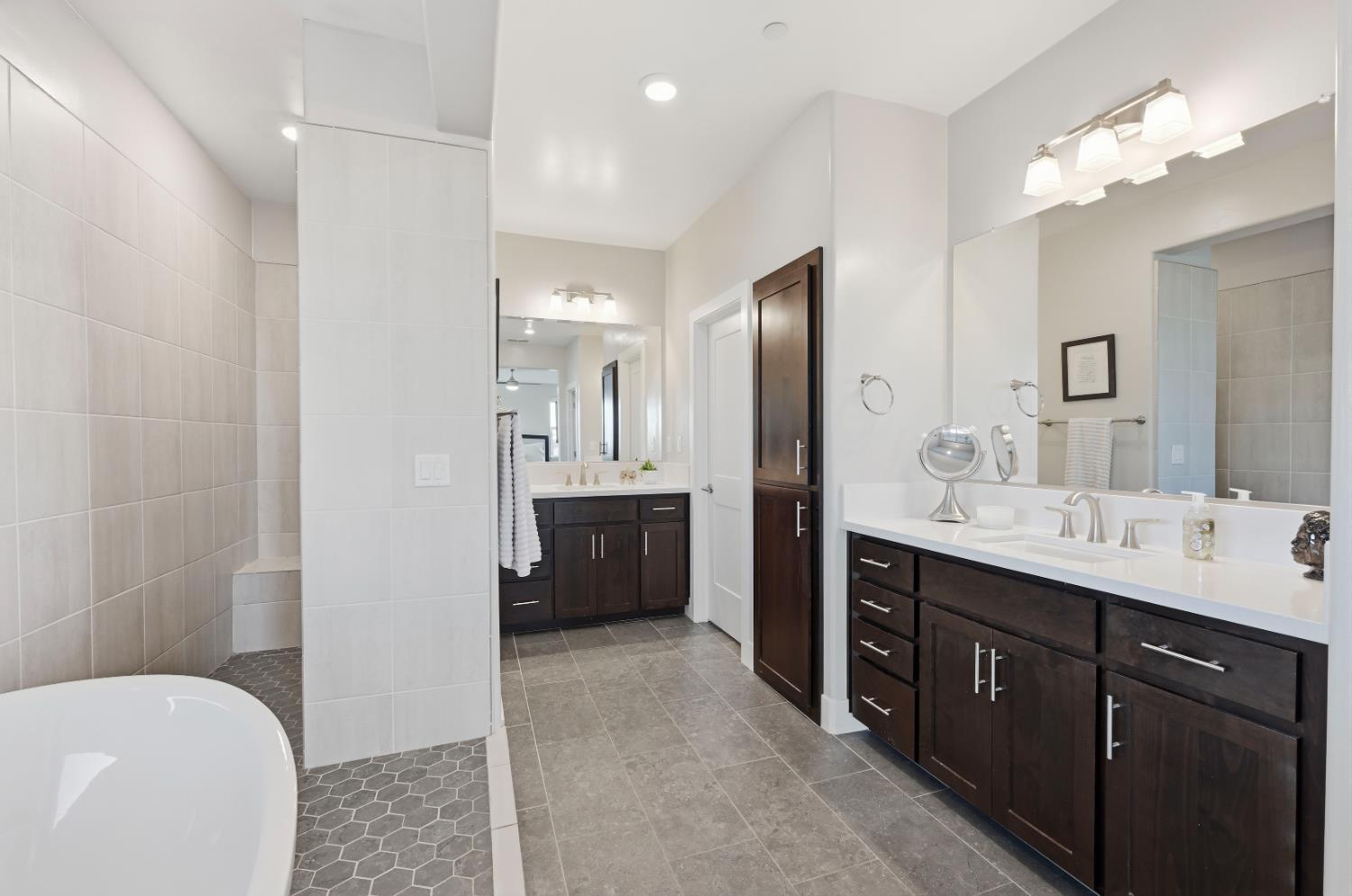 810 Broken Bit Court Rocklin, CA 95765 - Photo 28 of 47 a bathroom with a tub a sink double vanity and a mirror