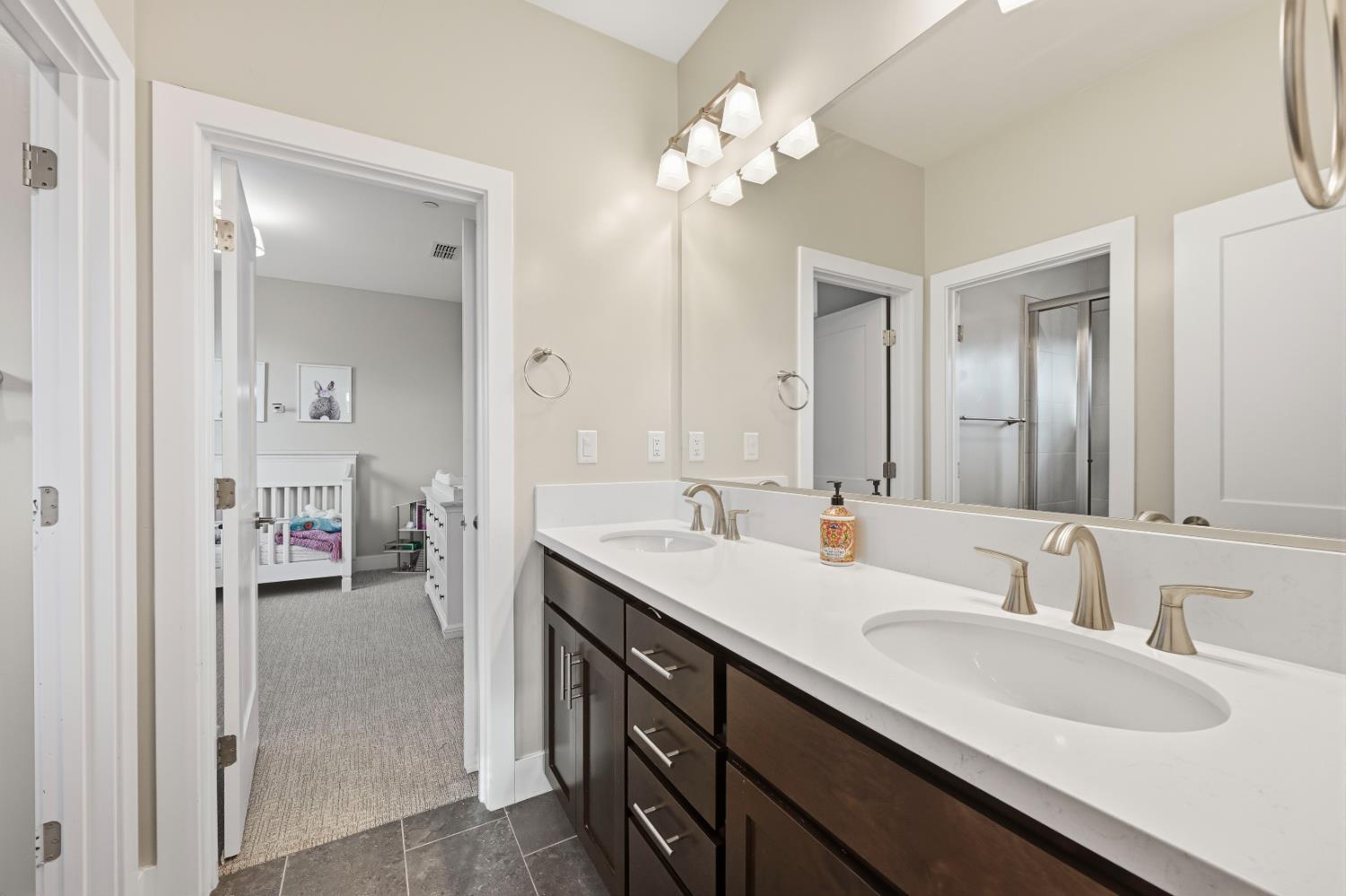 810 Broken Bit Court Rocklin, CA 95765 - Photo 31 of 47 a en suite bathroom with a double vanity sink and a mirror