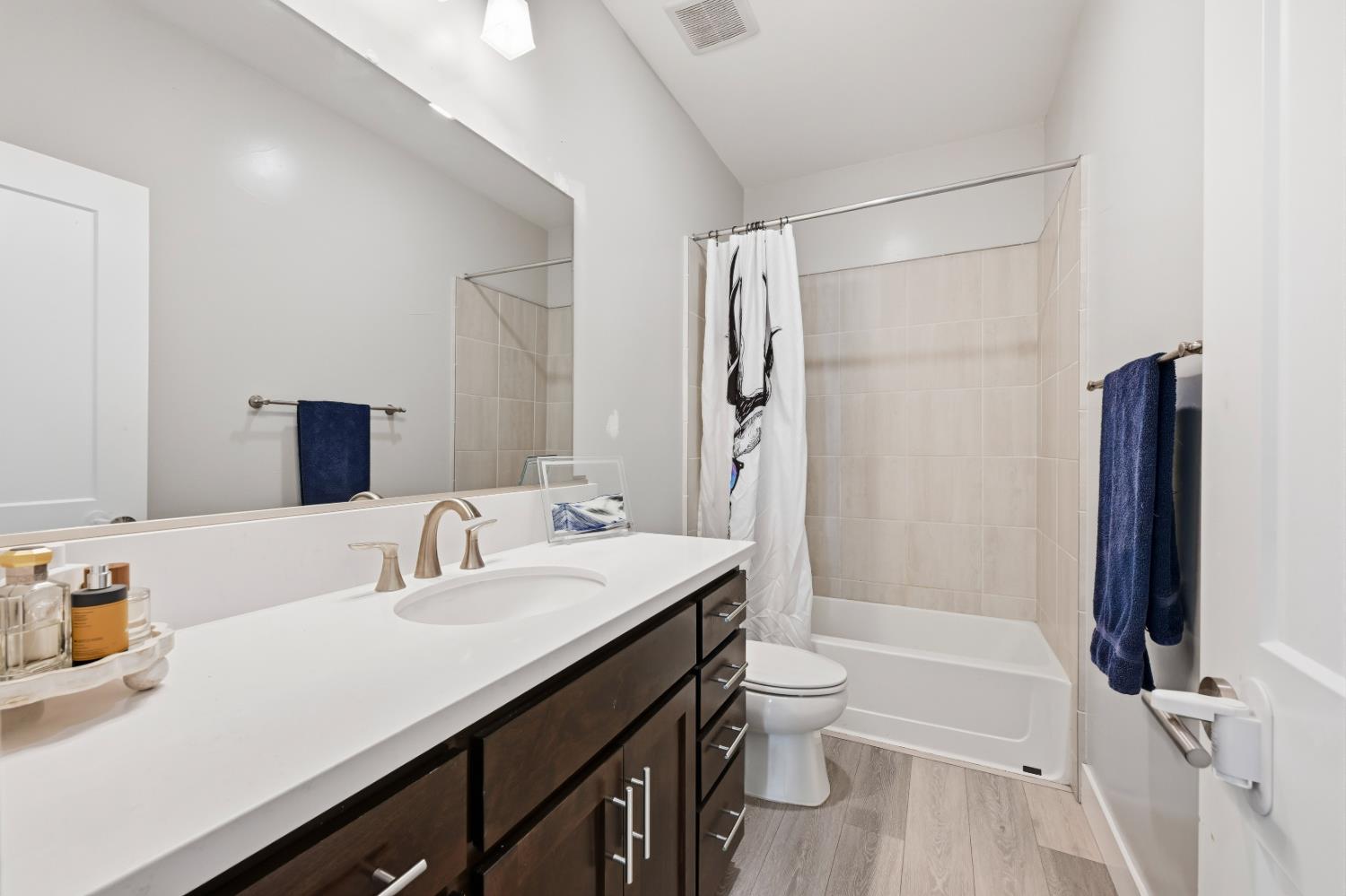 810 Broken Bit Court Rocklin, CA 95765 - Photo 34 of 47 a bathroom with a granite countertop sink toilet and shower