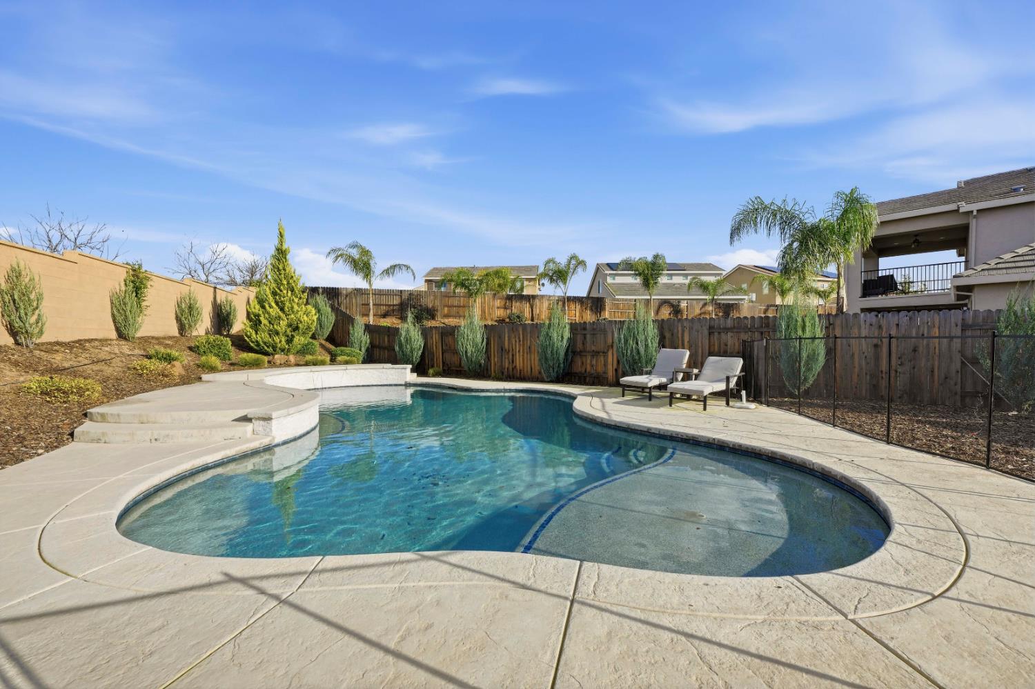 810 Broken Bit Court Rocklin, CA 95765 - Photo 42 of 47 a view of a swimming pool with a lounge chair