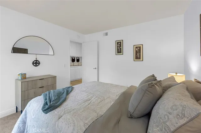 a bedroom with a bed and a dresser