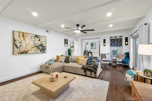 a living room with furniture or couch and a wooden floor