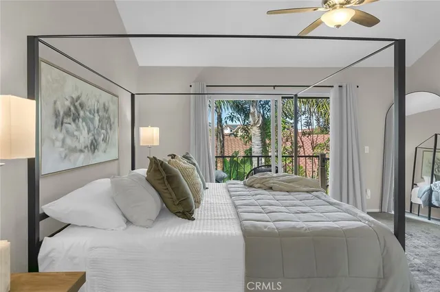 a bedroom with a large bed and a chandelier