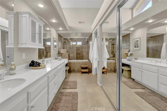 a en suite bathroom with double vanity and a shower