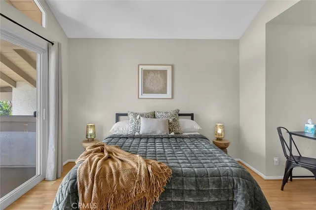 a bedroom with a bed and wooden floor