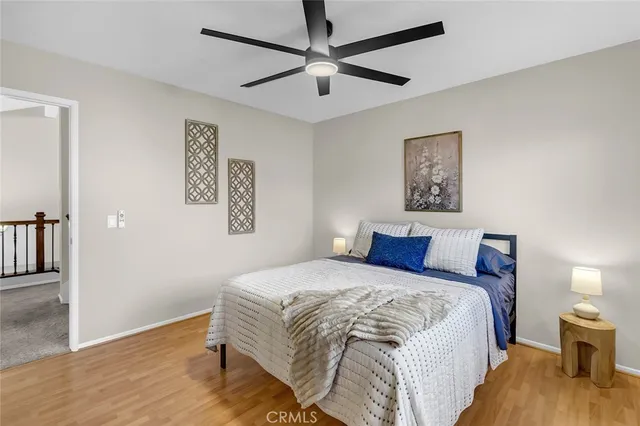 a bedroom with a bed and a painting on the wall