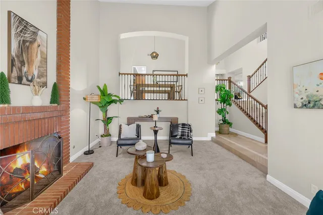 a living room with furniture a fireplace and a potted plant