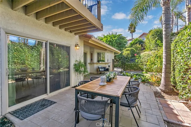 a view of a backyard with a patio and outdoor seating