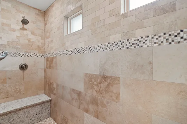 a spacious bathroom with a granite countertop sink and a mirror