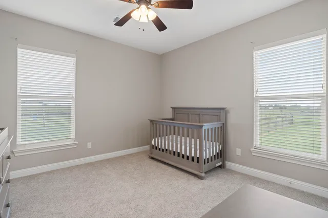 a bathroom with a granite countertop sink a toilet and a mirror