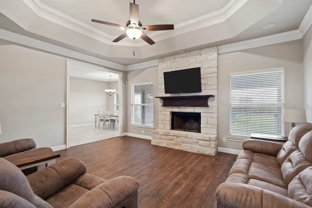a living room with furniture a flat screen tv and a fireplace