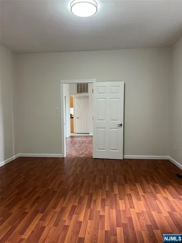 a view of a room with wooden floor