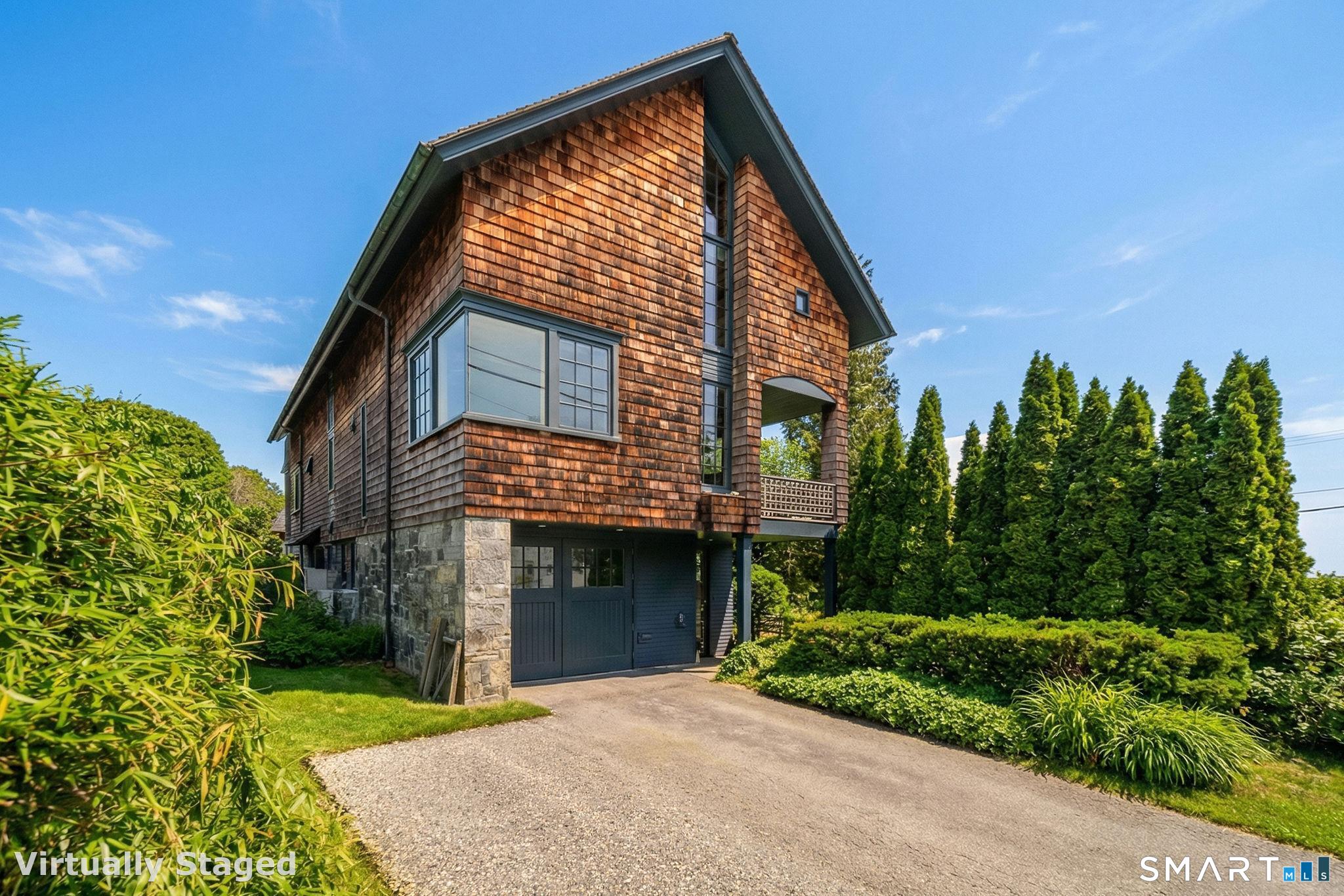 61 Hartford Avenue Madison, CT 06443 - Photo 3 of 40 a front view of a house with a yard and trees