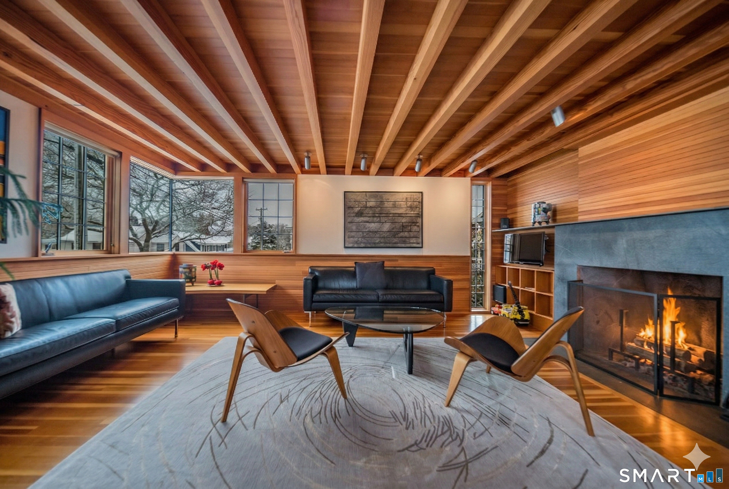 61 Hartford Avenue Madison, CT 06443 - Photo 32 of 40 a living room with furniture a fireplace and a ceiling fan
