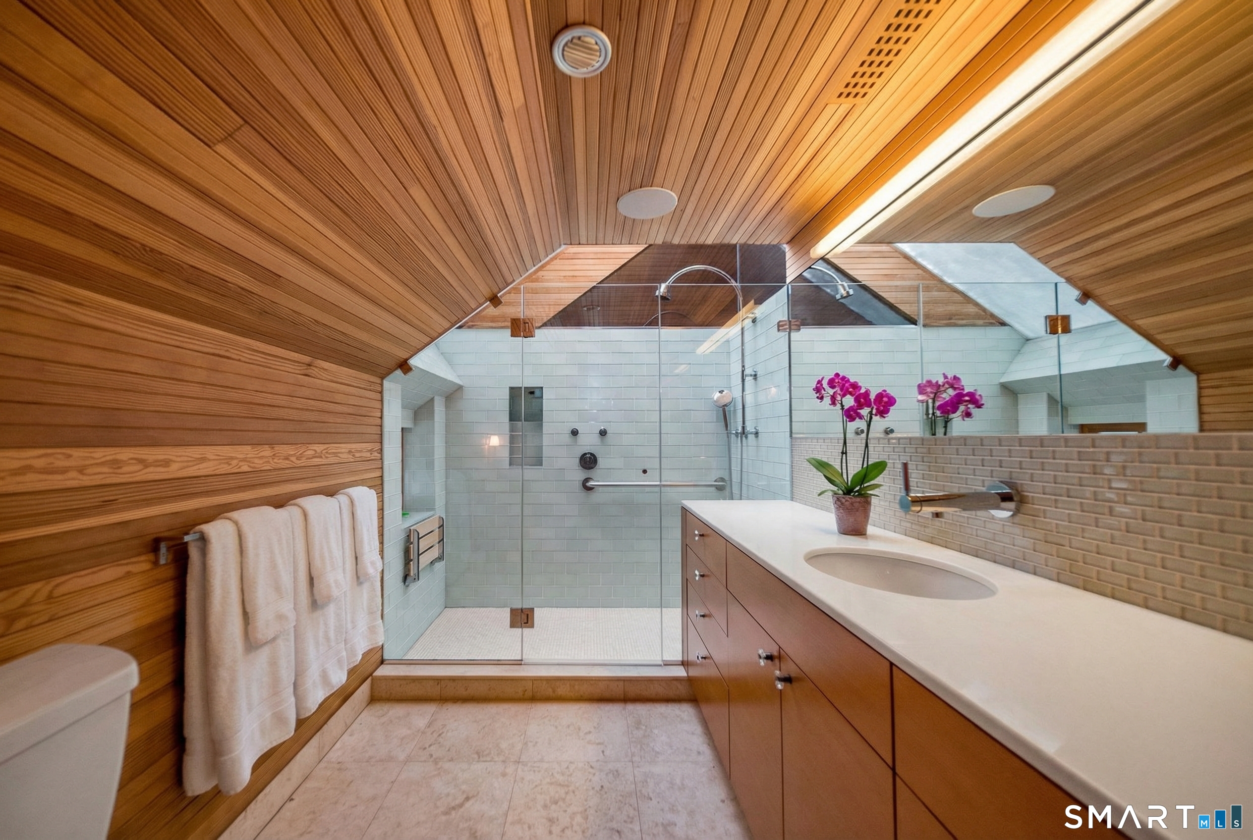 61 Hartford Avenue Madison, CT 06443 - Photo 33 of 40 a bathroom with a sink a mirror and shower