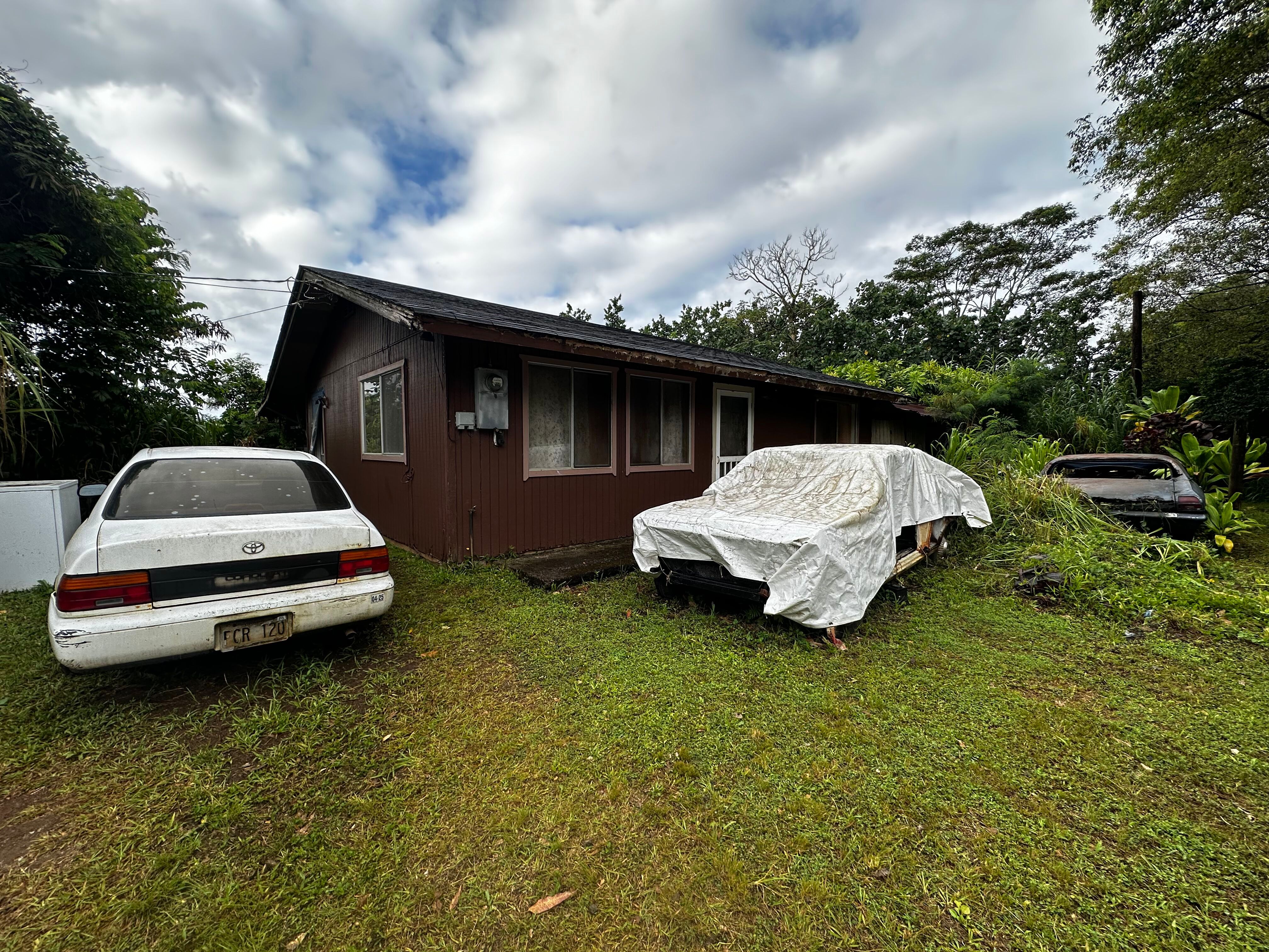 4373 Upa Road Koloa, HI 96756 - Photo 3 of 19 a car parked in front of a house with a garden