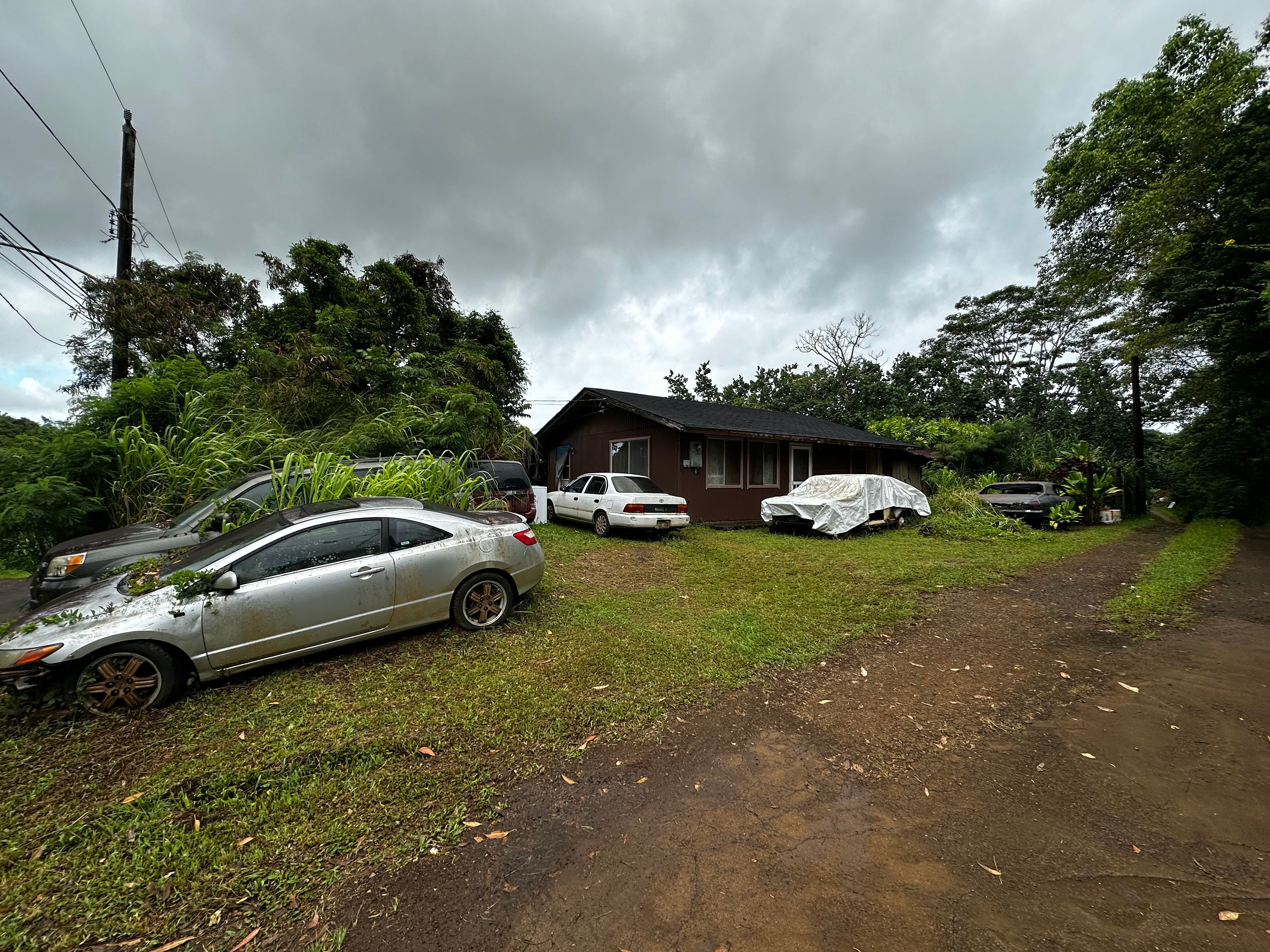 4373 Upa Road Koloa, HI 96756 - Photo 4 of 19 a couple of cars parked in front of a house