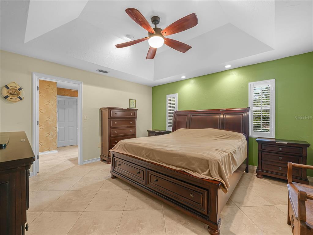 5001 Lakewood Road Sebring, FL 33875 - Photo 11 of 28 a bed room with a bed and a ceiling fan