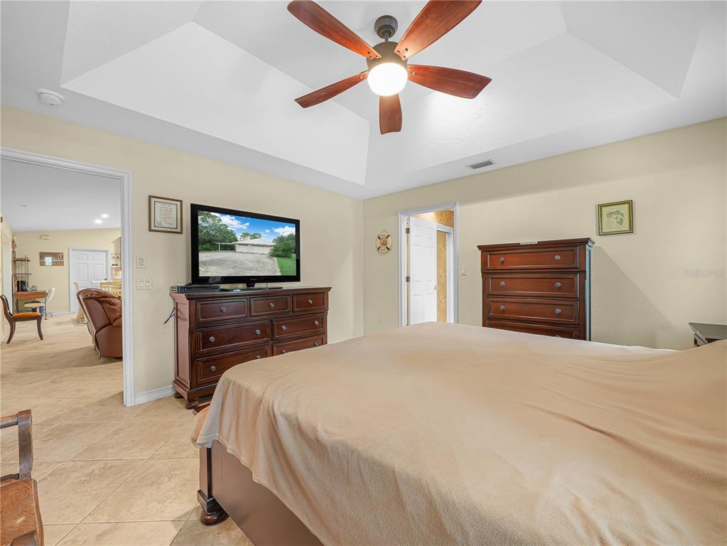 5001 Lakewood Road Sebring, FL 33875 - Photo 12 of 28 a bedroom with a bed and a flat screen tv
