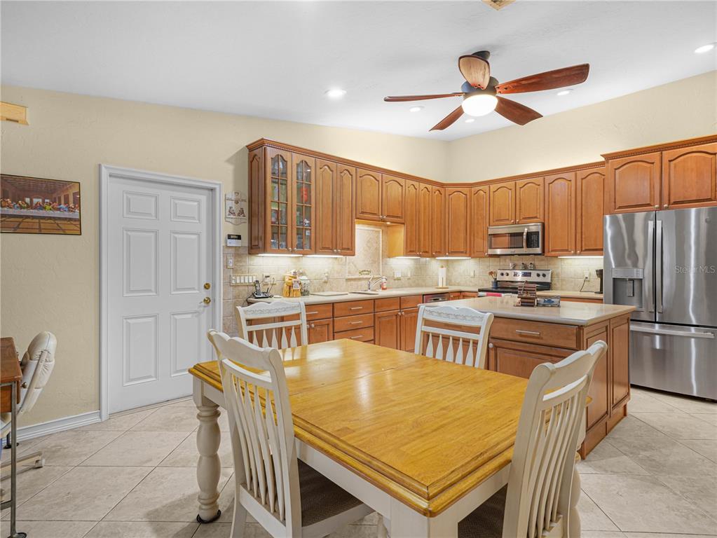 5001 Lakewood Road Sebring, FL 33875 - Photo 7 of 28 a kitchen with stainless steel appliances granite countertop a stove a sink a refrigerator and a refrigerator