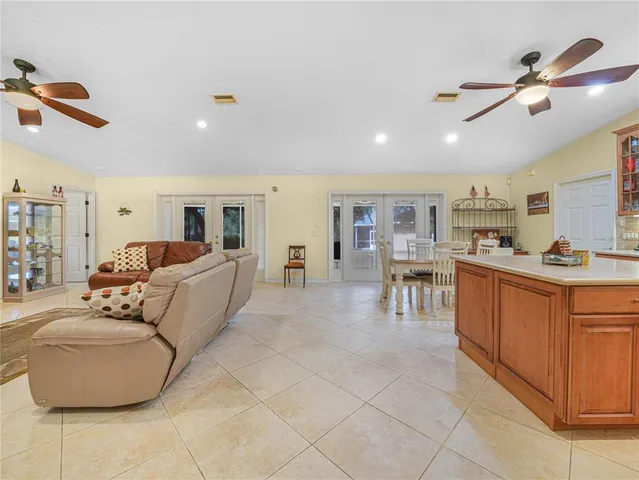 a living room with furniture and kitchen view
