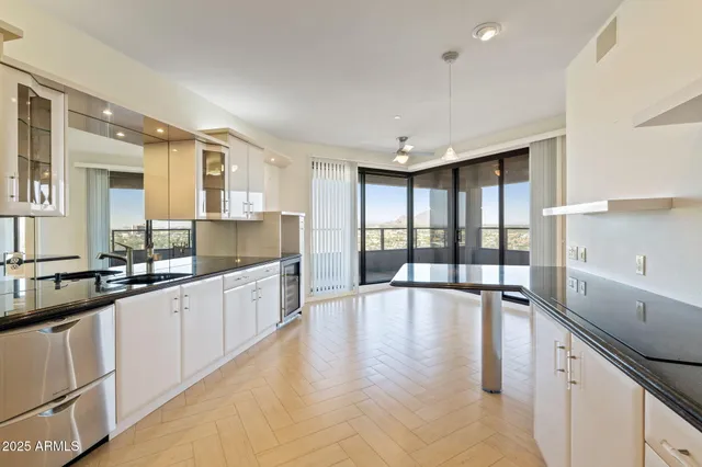 a large kitchen with granite countertop a large counter top and sink