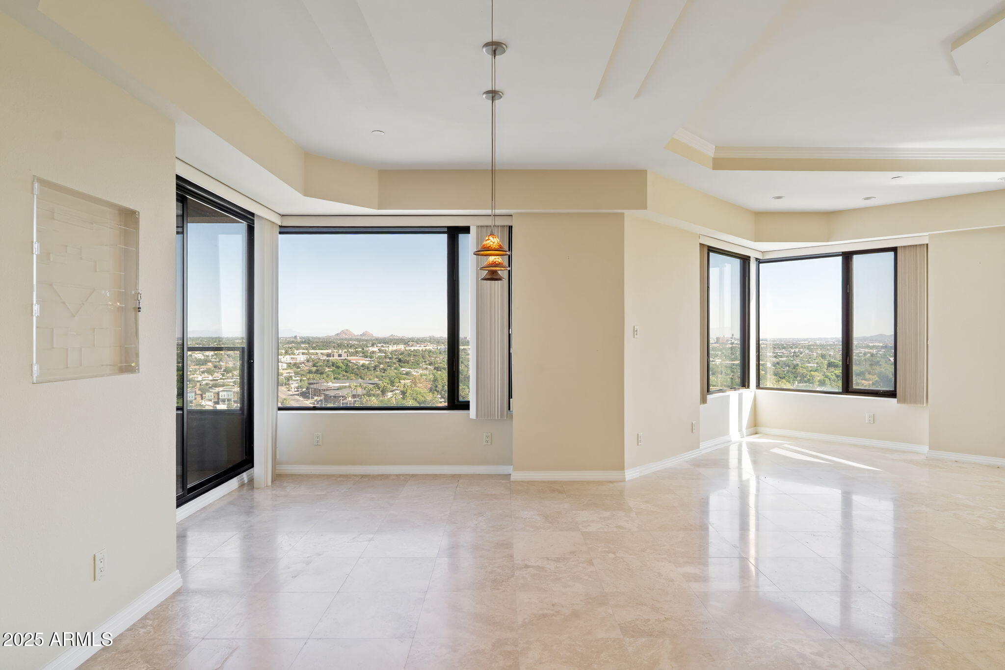 1040 East Osborn Road, Unit 1602 Phoenix, AZ 85014 - Photo 15 of 66 a view of a room with window ceiling fan and front door