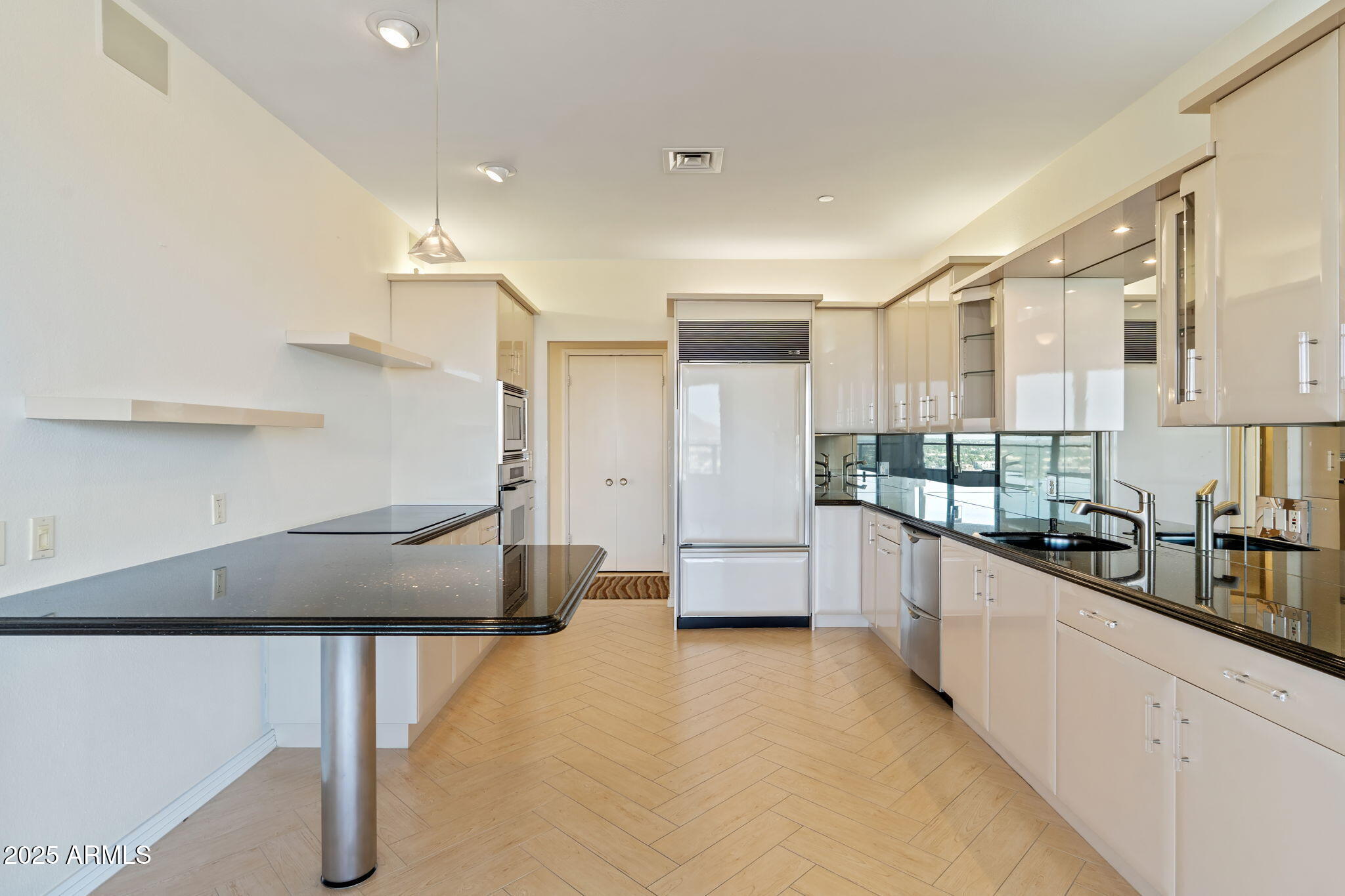 1040 East Osborn Road, Unit 1602 Phoenix, AZ 85014 - Photo 20 of 66 a kitchen with stainless steel appliances a refrigerator a sink a stove and white cabinets