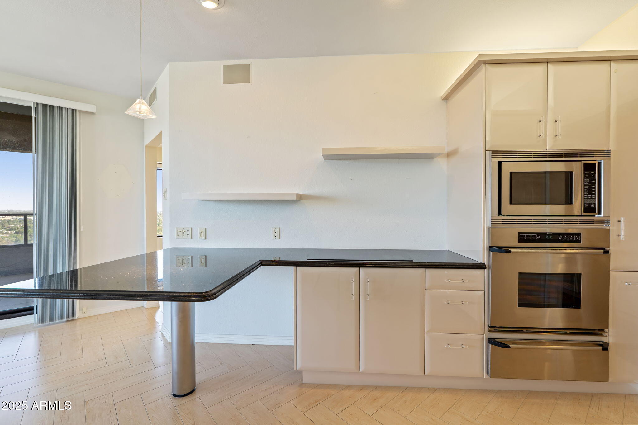 1040 East Osborn Road, Unit 1602 Phoenix, AZ 85014 - Photo 21 of 66 a kitchen with stainless steel appliances a stove a microwave and a refrigerator
