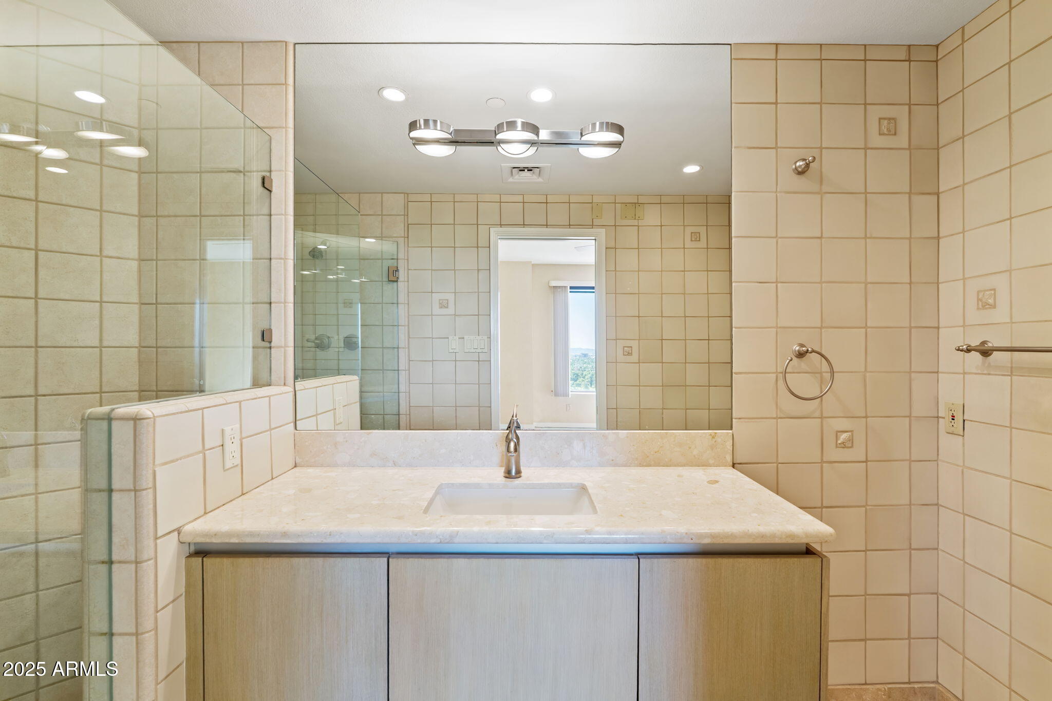 1040 East Osborn Road, Unit 1602 Phoenix, AZ 85014 - Photo 55 of 66 a bathroom with a sink shower and a mirror